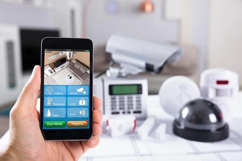 Hand holding smartphone running Total Connect 2.0 home security app